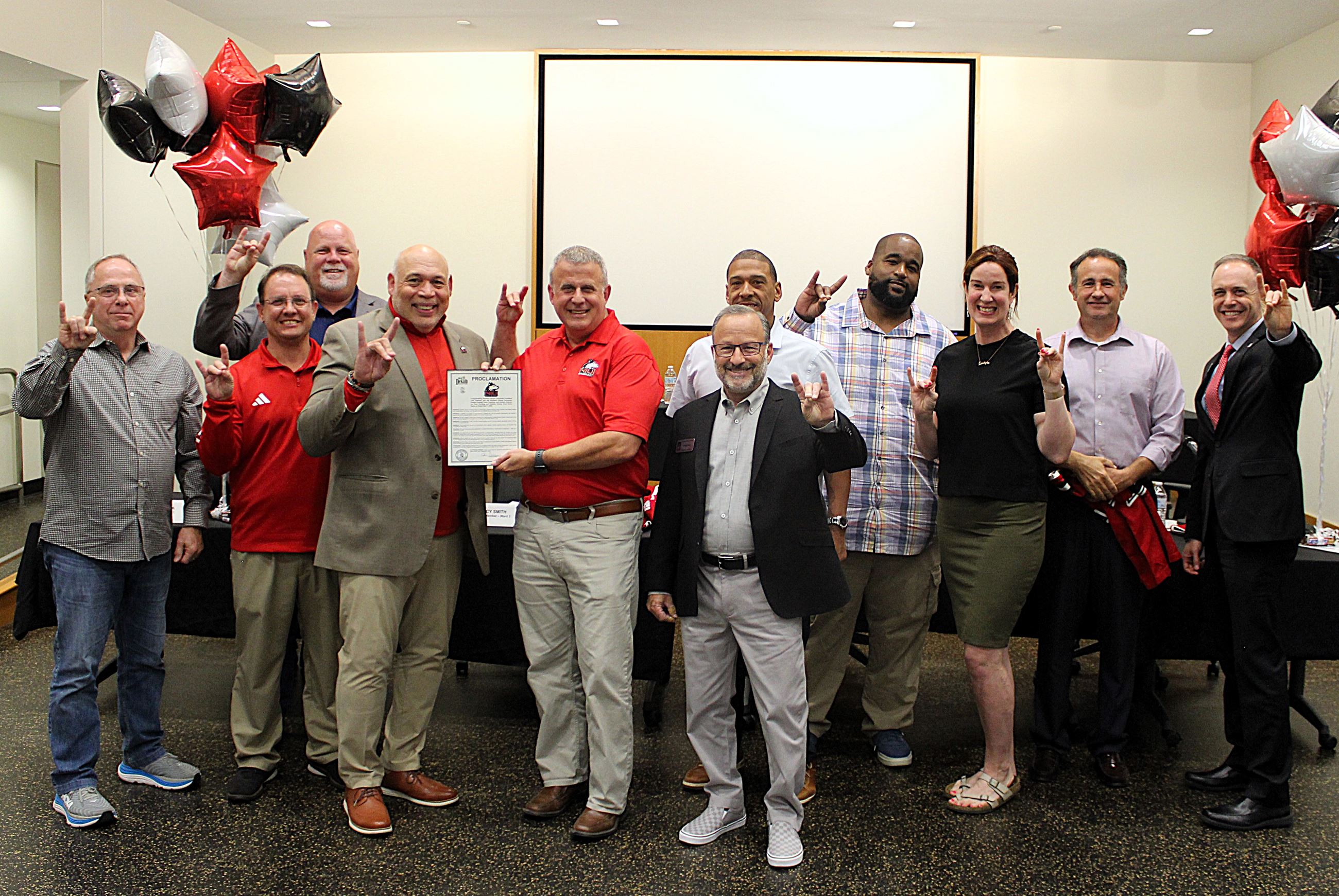 Mayor Cohen Barnes and the City Council present NIU with a congratulatory proclamation.