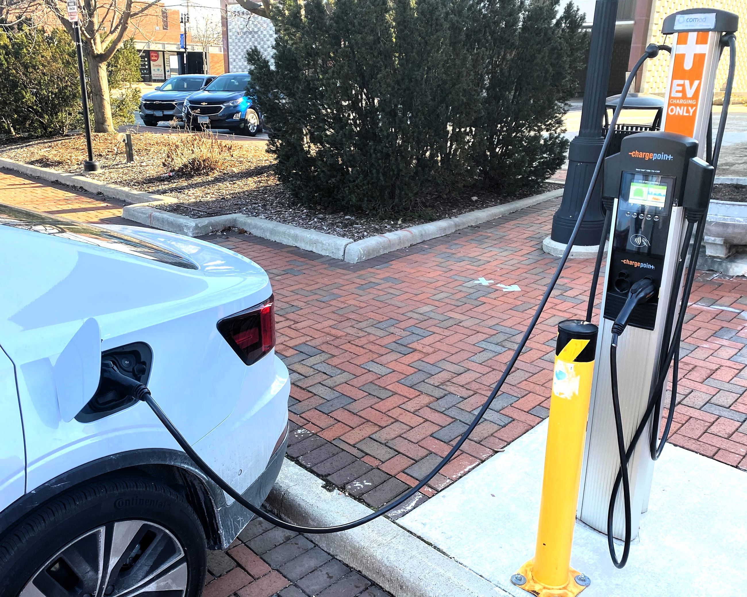 A car plugged in at the EV charger in Van Buer Plaza